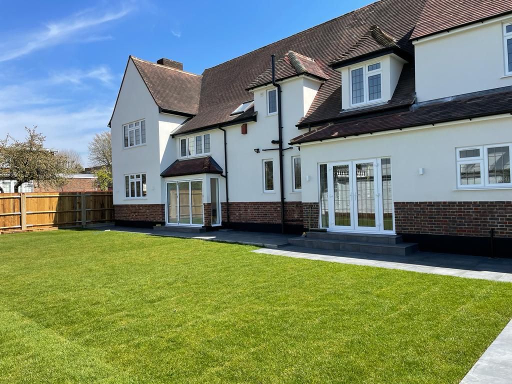 Large detached house refurbished by VAA Construction, rendered exterior with new lawn and patio, VAA Construction Ltd, builders based in South Ockendon RM15