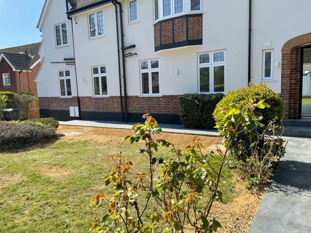 Refurbished detached house with rendered exterior and new lawn