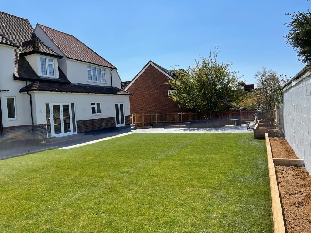 Rendered house exterior with new patio, paths and lawn