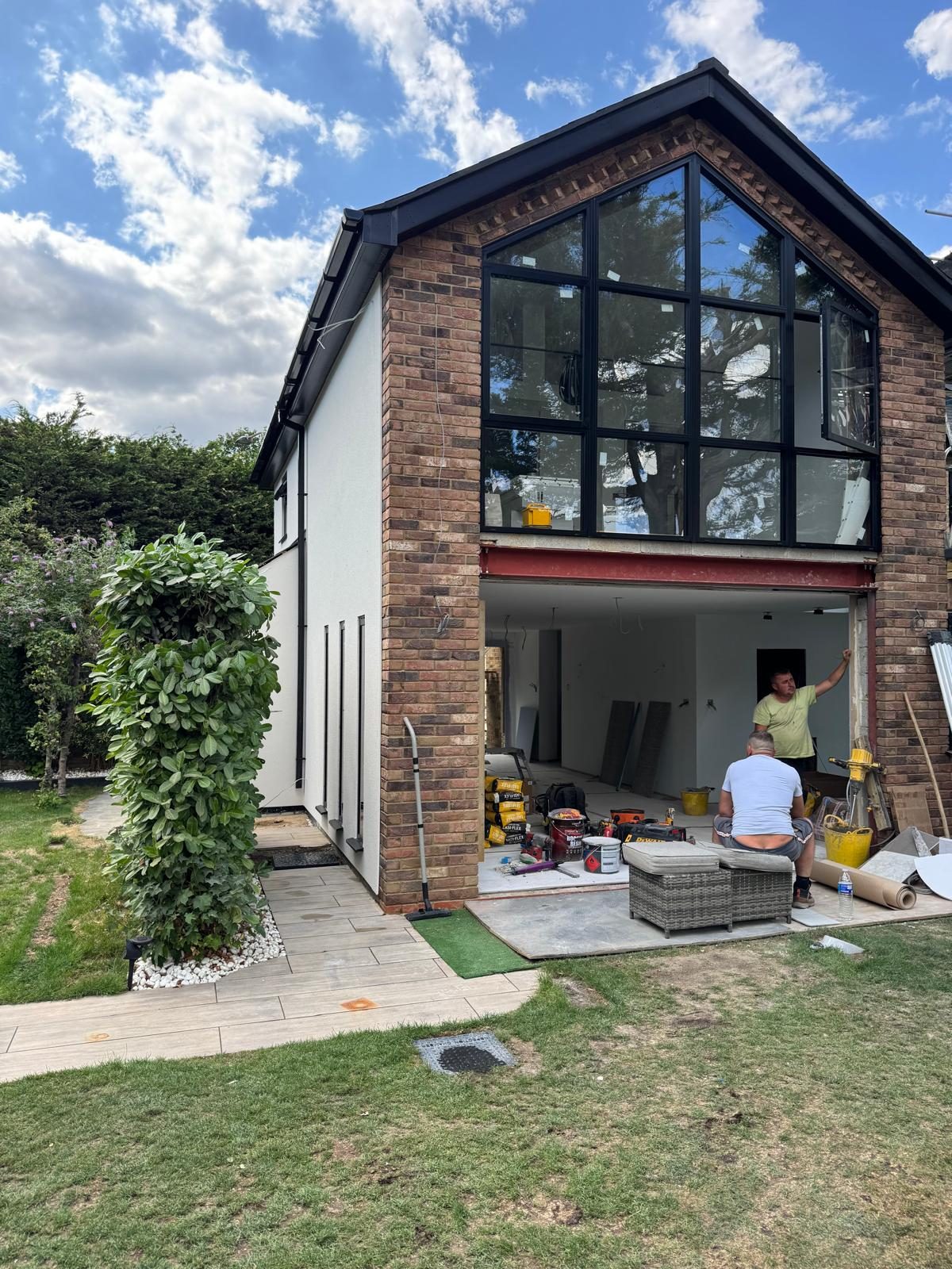 Glazed gable extension with the sliding doors open during the internal fit-out